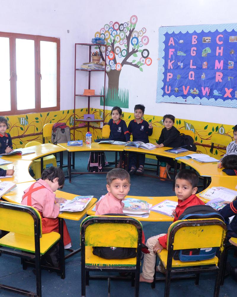An early-years class working together around a shared table